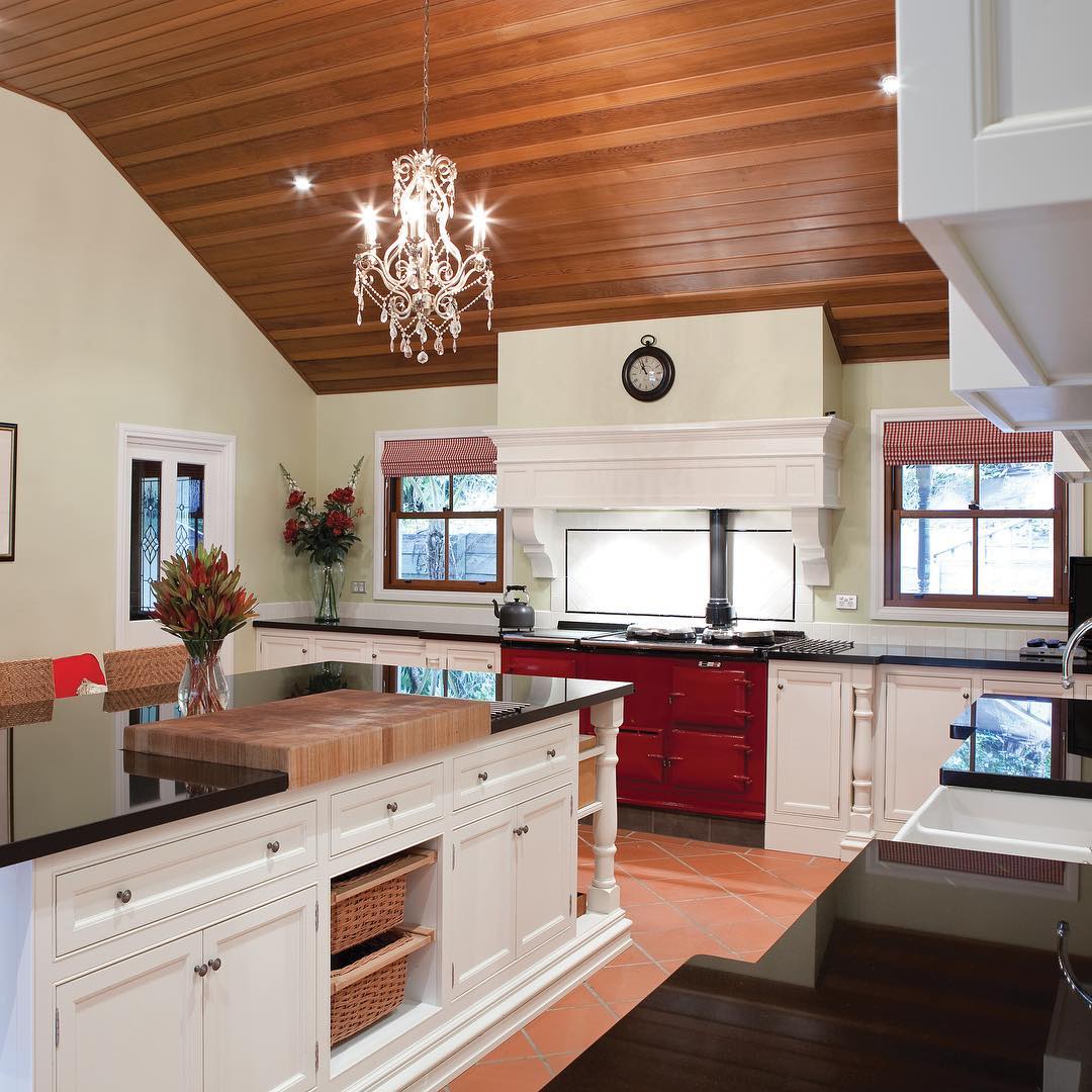 Definitely something special about this kitchen. Timber lined cathedral ceiling, custom made mantel, and a huge hand made, solid timber chopping block intergrated into an impressive Jet Black stone island benchtop.  made kitchen